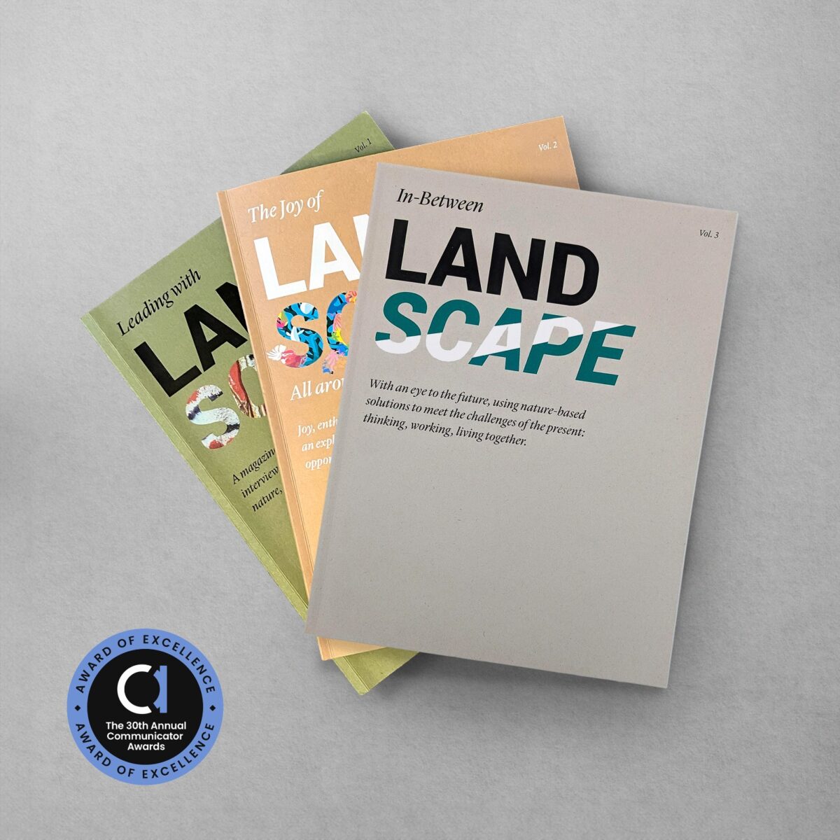 Our three LANDmagazines with the Award Badge