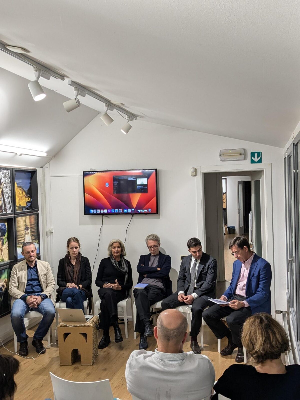 Five people, three women and three men, on chairs for a presentation