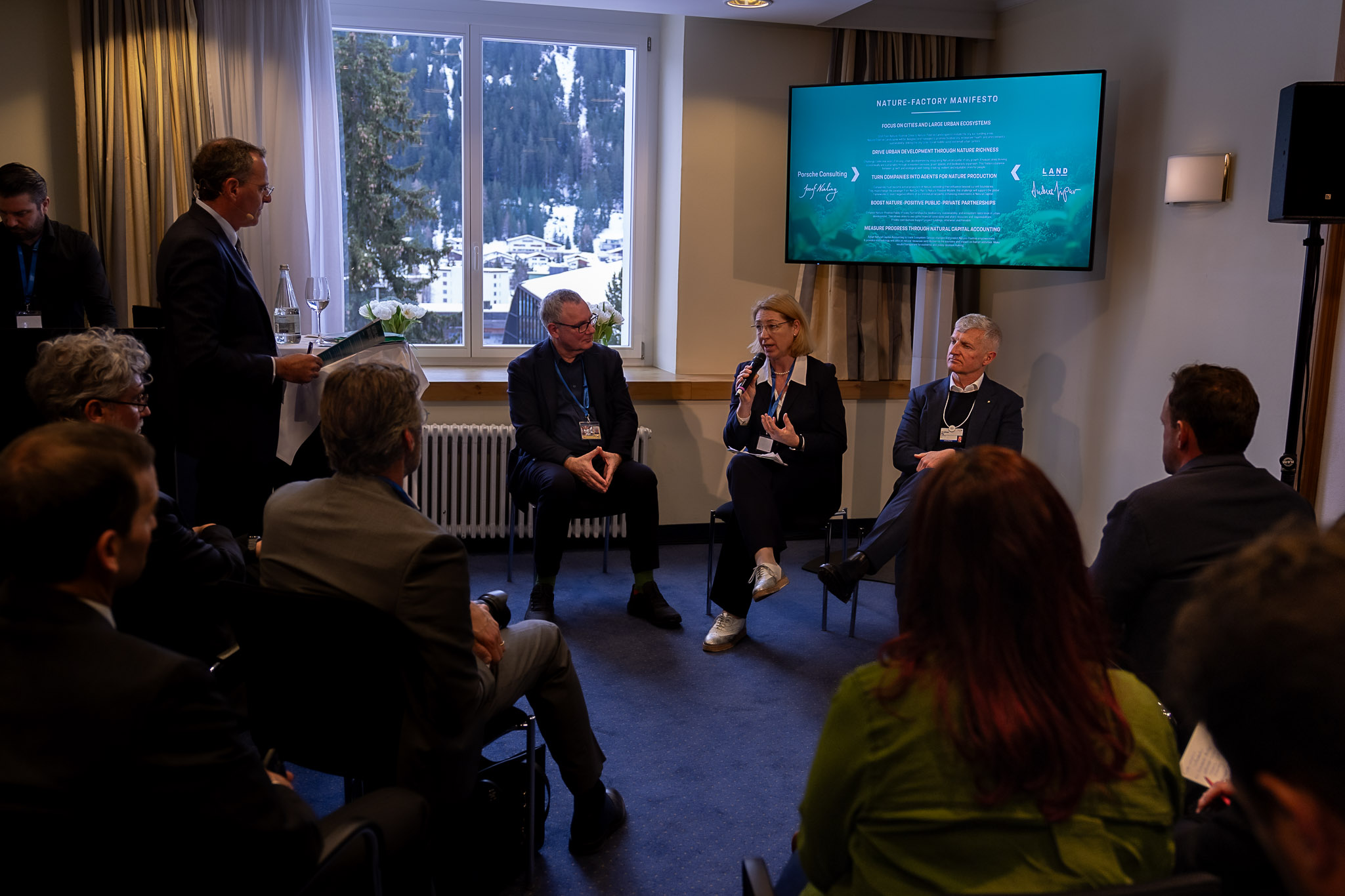 3 persons sitting in a room presenting