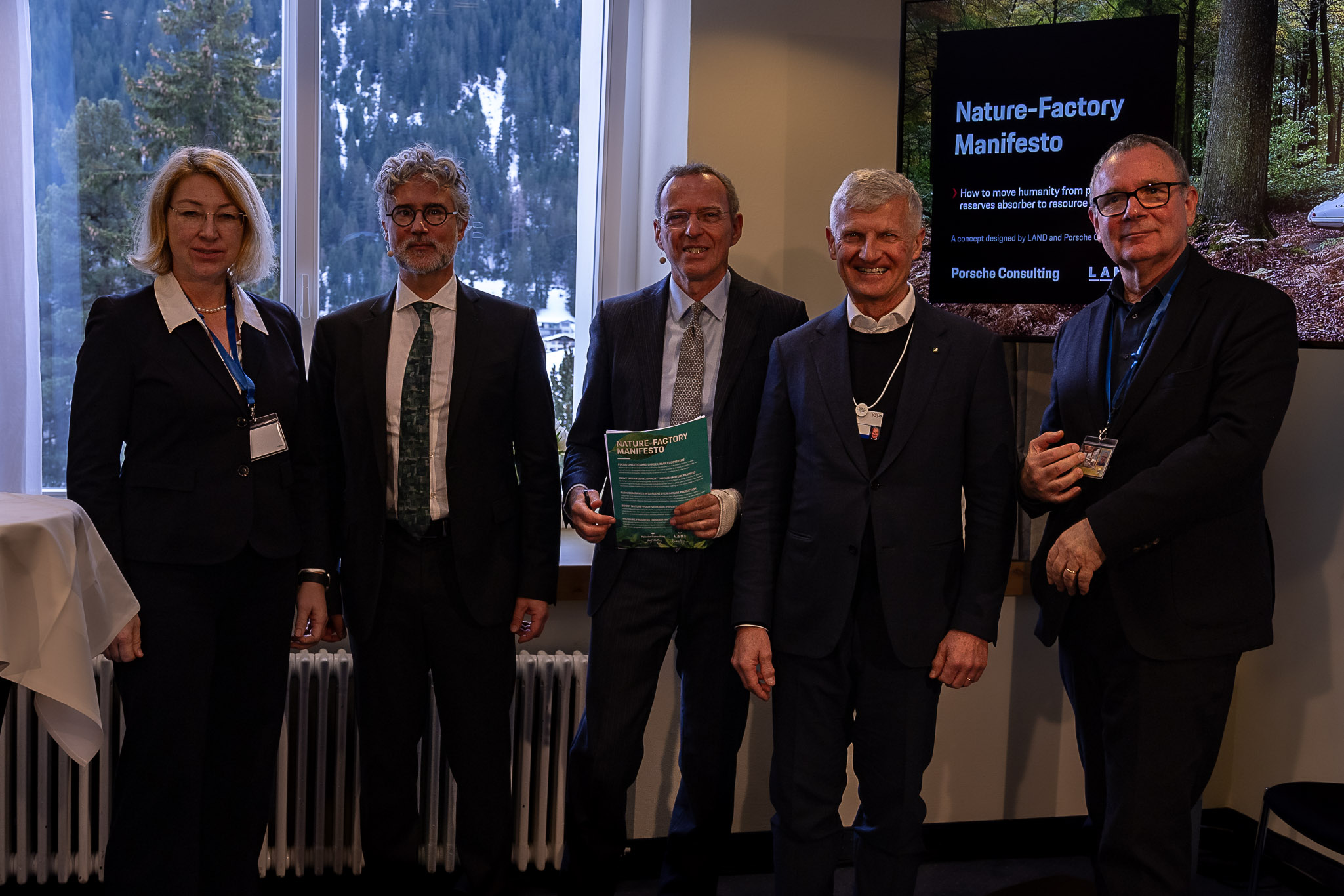 5 persons standing in front of a presentation