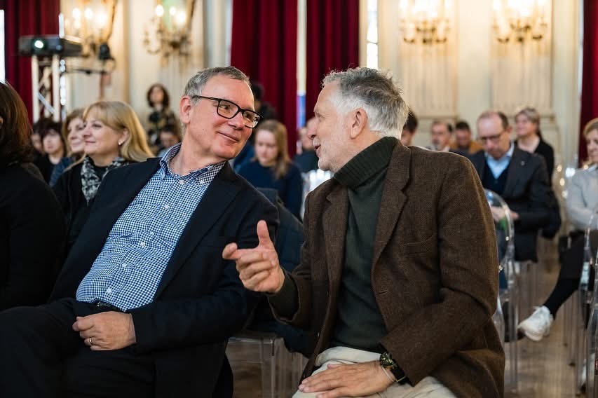 two men sitting and talking