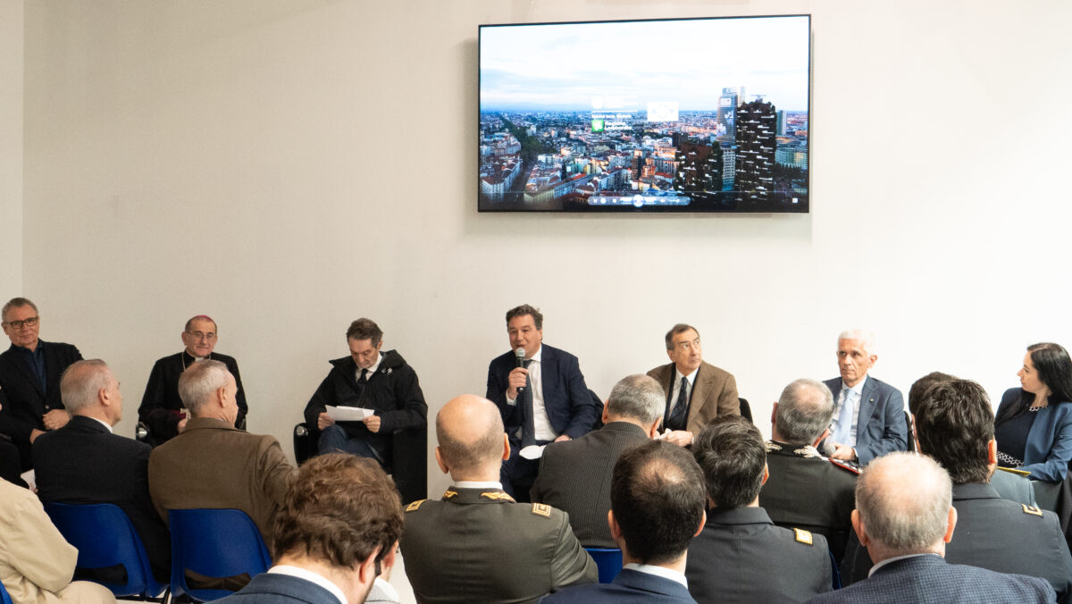 a group of speakers sitting in front of an audience