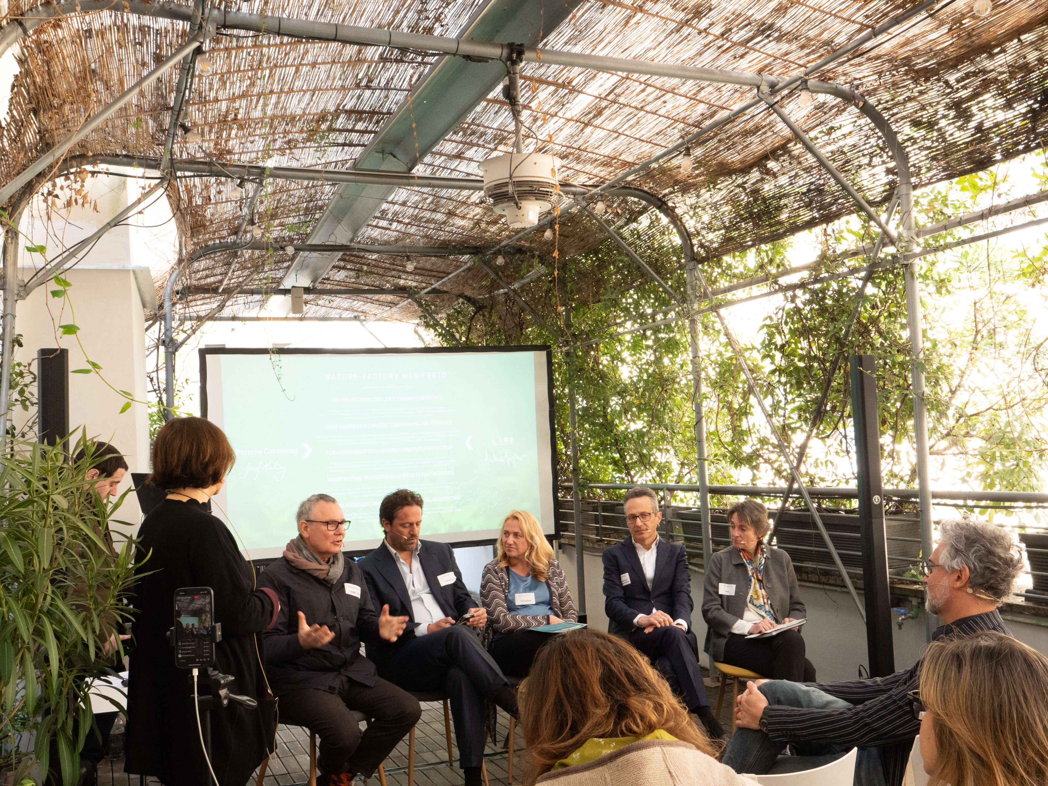 a group of people sitting and talking to an audience