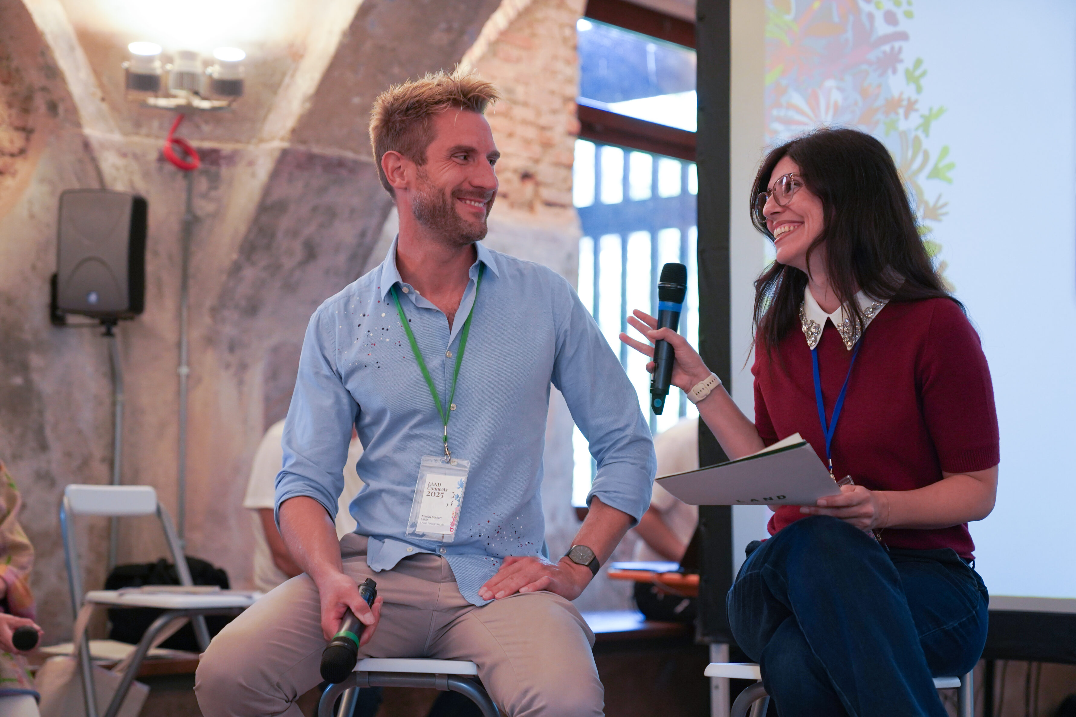 a man and a woman smiling and sitting together