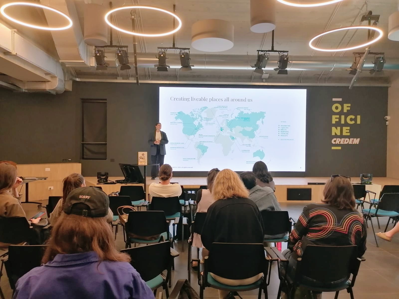 A woman speaking to an audience from a stage